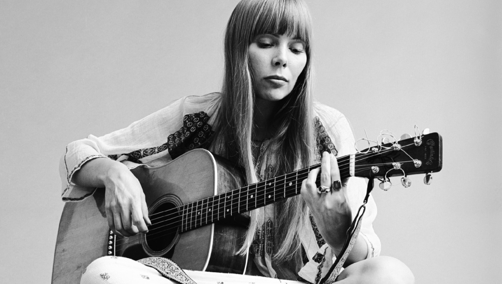 Joni Mitchell in the 70s playing the guitar